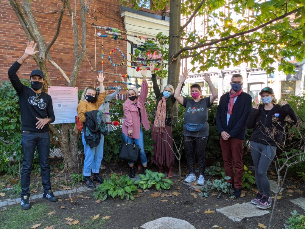 Story Stick Project Exhibit launch group shot with lead artist Pamela Schuller, participants, and community champions